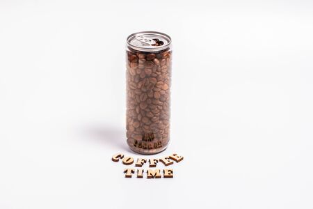 Coffee beans in a plastic jar on a white backgroundの写真素材