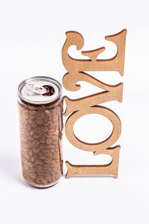 Coffee beans in a plastic jar on a white backgroundの写真素材