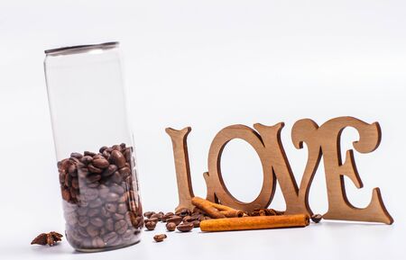 Coffee beans in a plastic jar on a white backgroundの写真素材
