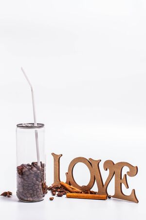 Coffee beans in a plastic jar on a white backgroundの写真素材