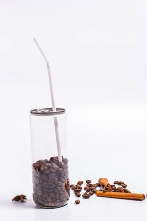 Coffee beans in a plastic jar on a white backgroundの写真素材