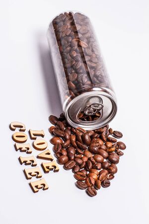 Coffee beans in a plastic jar on a white backgroundの写真素材