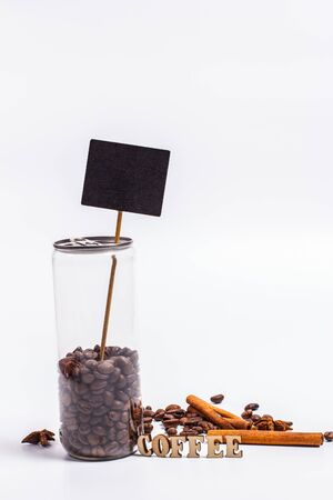 Coffee beans in a plastic jar on a white backgroundの写真素材