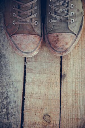 Green old sneakers on a man's footの写真素材