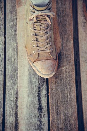 Green old sneakers on a man's foot