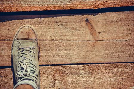 Green old sneakers on a man's footの写真素材