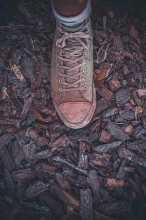 Green old sneakers on a man's footの写真素材