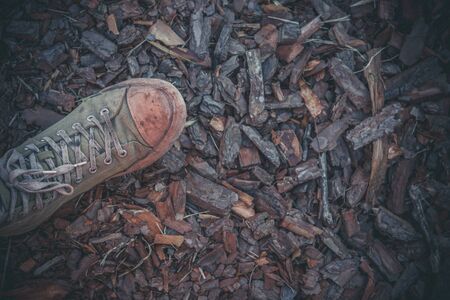 Green old sneakers on a man's footの写真素材