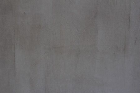 Gray concrete wall texture with scratches and cracks on it.