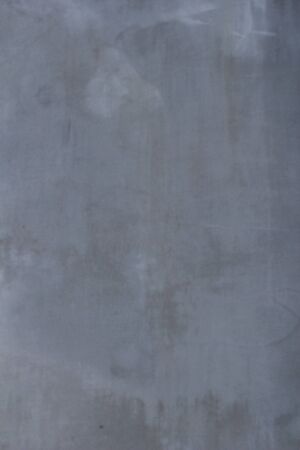 Gray concrete wall texture with scratches and cracks on it.の写真素材