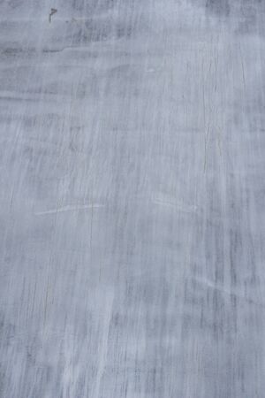Gray concrete wall texture with scratches and cracks on it.の写真素材