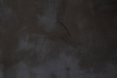 Gray concrete wall texture with scratches and cracks on it.の写真素材