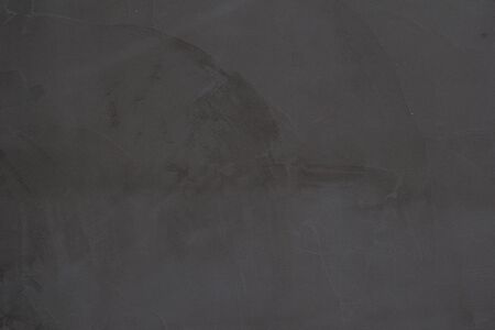Gray concrete wall texture with scratches and cracks on it.の写真素材