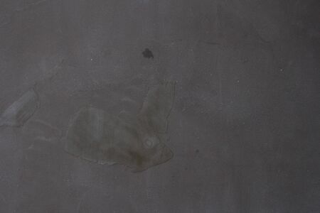 Gray concrete wall texture with scratches and cracks on it.の写真素材