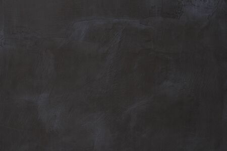 Gray concrete wall texture with scratches and cracks on it.の写真素材