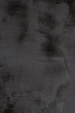 Gray concrete wall texture with scratches and cracks on it.の写真素材