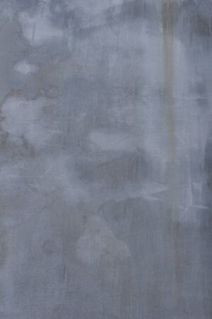 Gray concrete wall texture with scratches and cracks on it.の写真素材