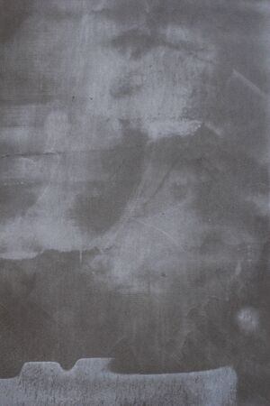 Gray concrete wall texture with scratches and cracks on it.の写真素材