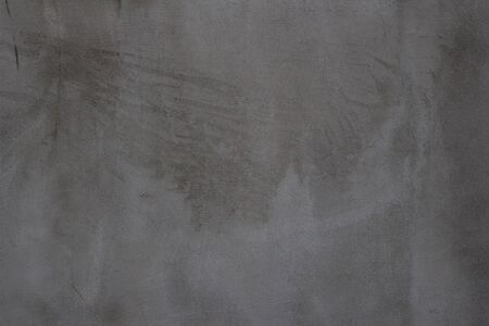 Gray concrete wall texture with scratches and cracks on it.の写真素材