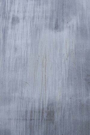 Gray concrete wall texture with scratches and cracks on it.の写真素材