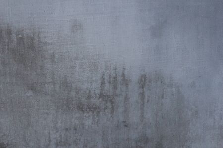 Gray concrete wall texture with scratches and cracks on it.の写真素材