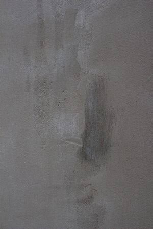 Gray concrete wall texture with scratches and cracks on it.の写真素材