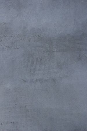 Gray concrete wall texture with scratches and cracks on it.の写真素材