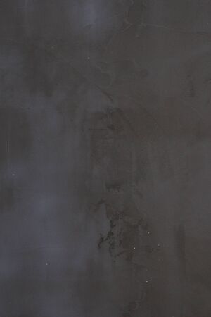 Gray concrete wall texture with scratches and cracks on it.の写真素材