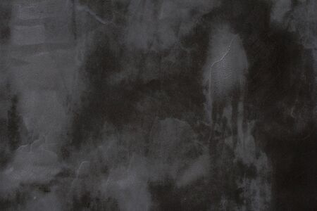 Gray concrete wall texture with scratches and cracks on it.の写真素材