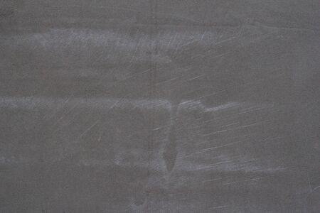 Gray concrete wall texture with scratches and cracks on it.の写真素材
