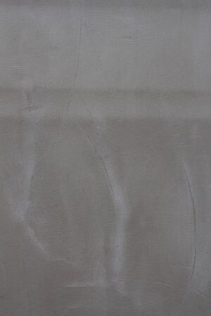 Gray concrete wall texture with scratches and cracks on it.の写真素材