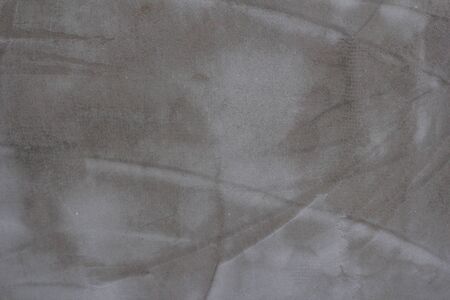 Gray concrete wall texture with scratches and cracks on it.の写真素材
