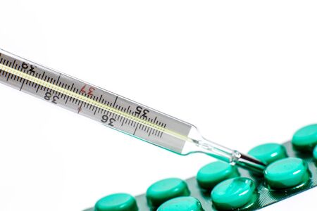Pills for various diseases and a thermometer for measuring body temperatureの写真素材