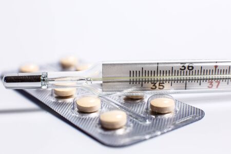 Pills for various diseases and a thermometer for measuring body temperatureの写真素材