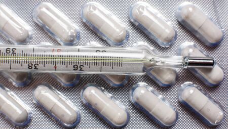 Pills for various diseases and a thermometer for measuring body temperatureの写真素材