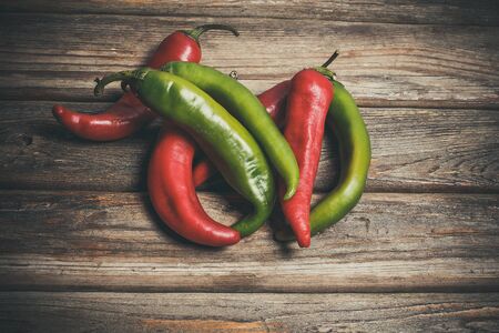 Hot peppers for spicy dishes on a wooden vintage tableの写真素材
