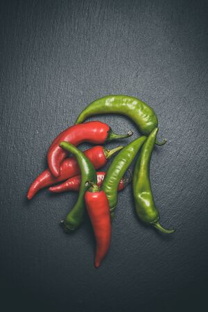 Hot peppers for spicy dishes on a black backgroundの写真素材