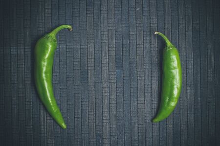 Hot peppers for spicy dishes on a black backgroundの写真素材