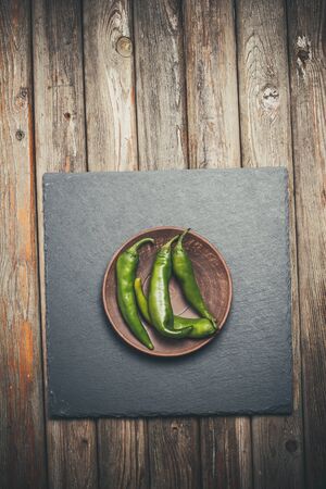 Hot peppers for spicy dishes on a wooden vintage tableの写真素材