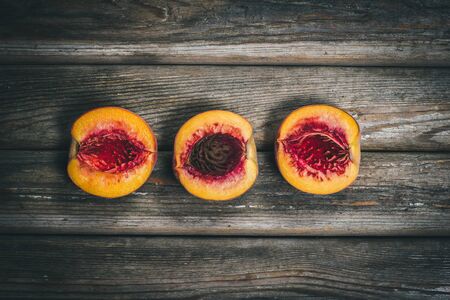 Ripe tasty peaches on a wooden brown surface in vintage style.の写真素材