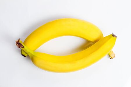Fresh and tasty yellow bananas for a healthy diet on a white backgroundの写真素材