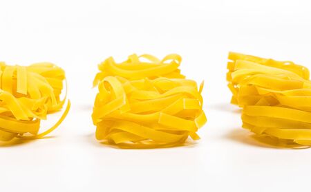 Raw delicious pasta for cooking on a white plate close