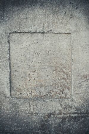 Old concrete dark wall of a destroyed house with scratches and cracksの写真素材
