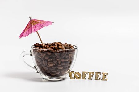 Cup with coffee grains on a white backgroundの写真素材