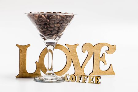 Coffee beans in a martini glass on a white backgroundの写真素材