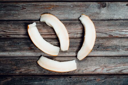 Tasty sweet and ripe melon on a vintage wooden tableの写真素材