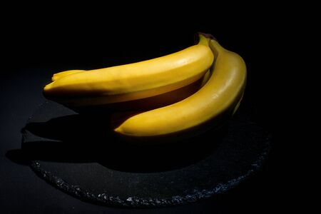 Ripe banana for diet and sports on a black background closeの写真素材