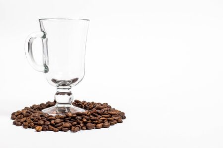 Glass of mulled wine and grains of coffee in it on a white background closeの写真素材