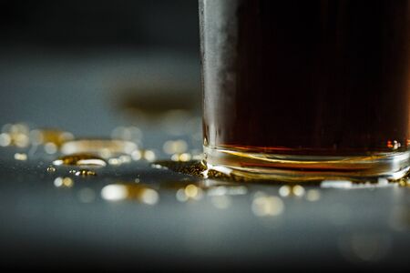 Soda in a glass on a black background with ice cubes and drops closeの写真素材