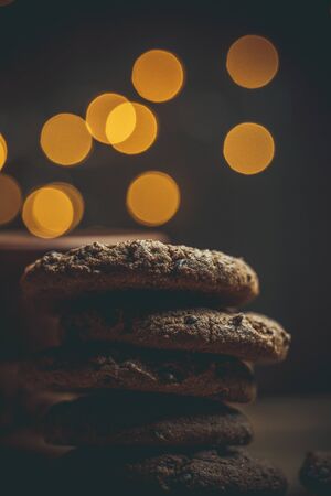 Chocolate chip cookies on a table in warm colors for coffee and moodの写真素材
